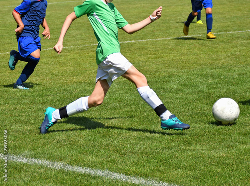 Fototapeta Naklejka Na Ścianę i Meble -  Young kids are playing soccer