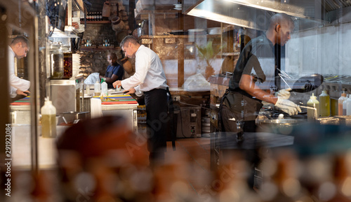 Men working in busy restaurant kitchen