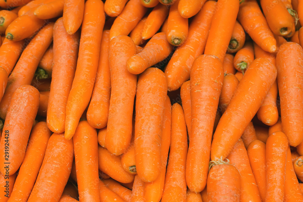 Fresh orange carrot close up at the market. Organic product suitable for vegetarians and vegans. Fresh orange carrot close up at the market. Organic product suitable for vegetarians and vegans.