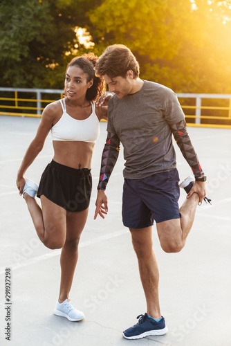 Photo of nice focused couple doing exercises together