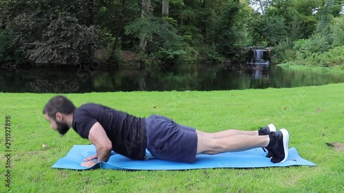 Man doing diamond push ups in park