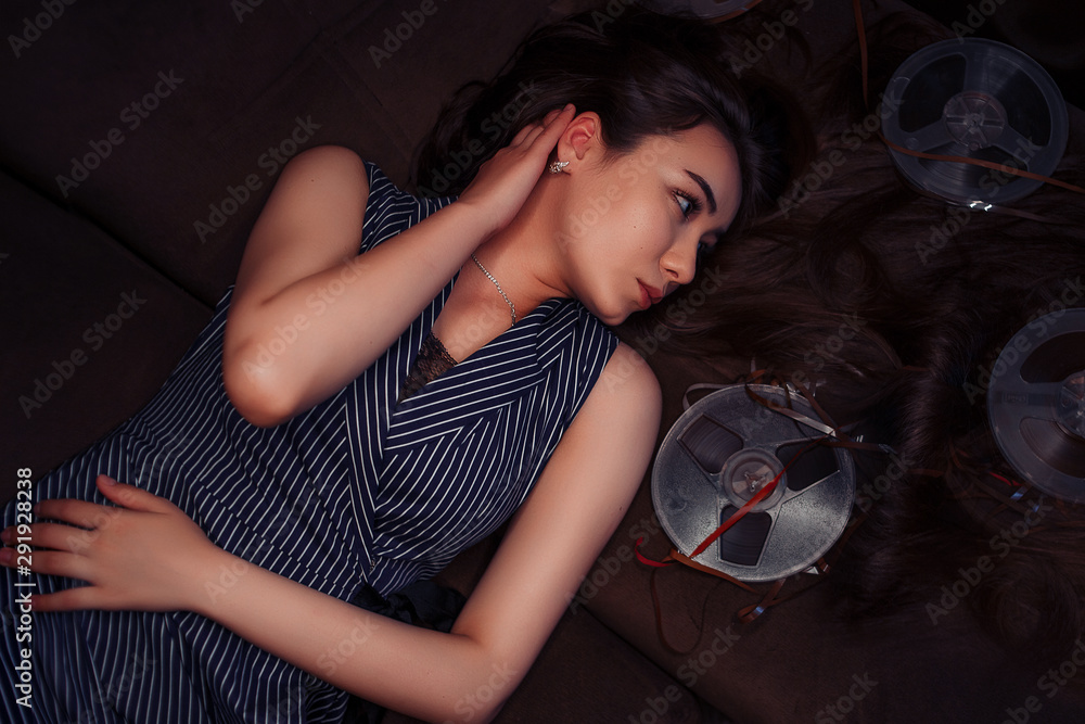 portrait of a young Asian girl in a blue striped dress lying on