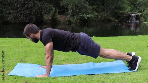 Man push ups spiderman in park