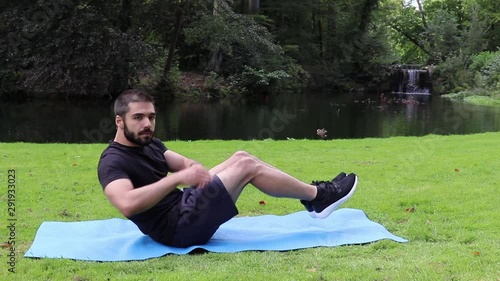 Man doing Russian twist in park
