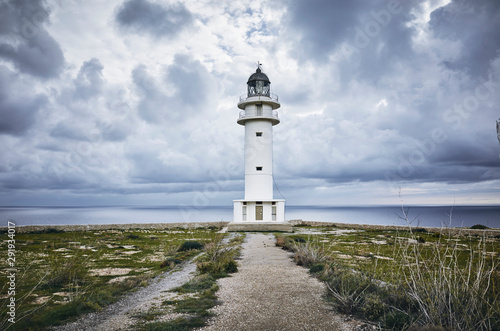 Barbaria Lighthouse in formentera Islan in spain with a cloudy sky before an storm