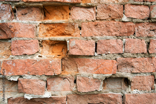 Texture of an old red stone brick wall