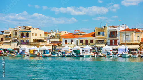 Port and waterfront with small houses in Aegina town photo