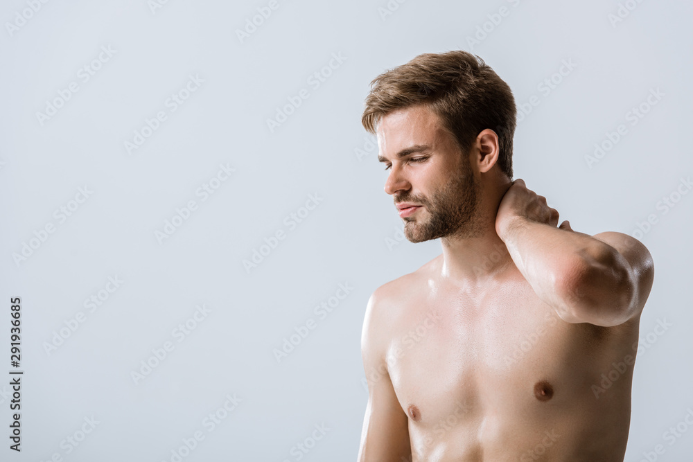 Fototapeta premium shirtless bearded man with neck pain isolated on grey