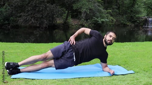 Man doing side plank in park 2