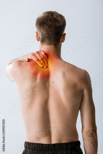 back view of shirtless man with neck pain isolated on grey