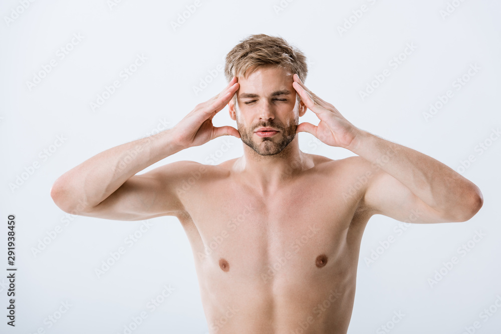 Fototapeta premium front view of shirtless man with migraine touching temples isolated on grey