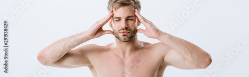 panoramic shot of shirtless man with migraine touching temples isolated on grey