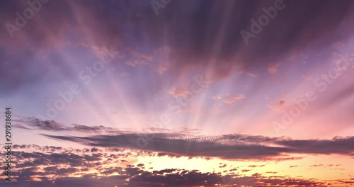 Dramatic Time Lapse Sunset over Storm Clouds. Evening, Large beautiful orange color sunset sky. Red purple orange blue pink. Landscape of Storm clouds moving across the sky against the setting sun.