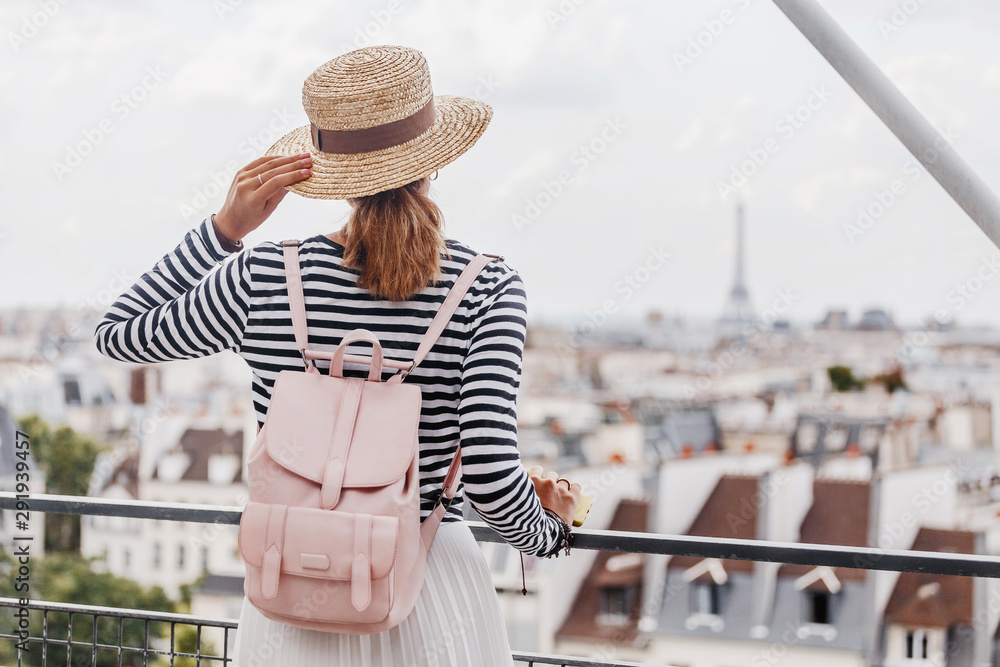 Happy Asian girl enjoys a Grand view of Paris from the height of the observation deck