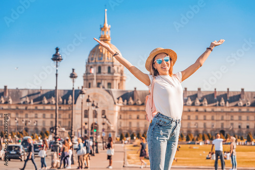Asian happy girl traveler posing in the square near the Invalides In Paris. Lifestyle and tourism in France photo