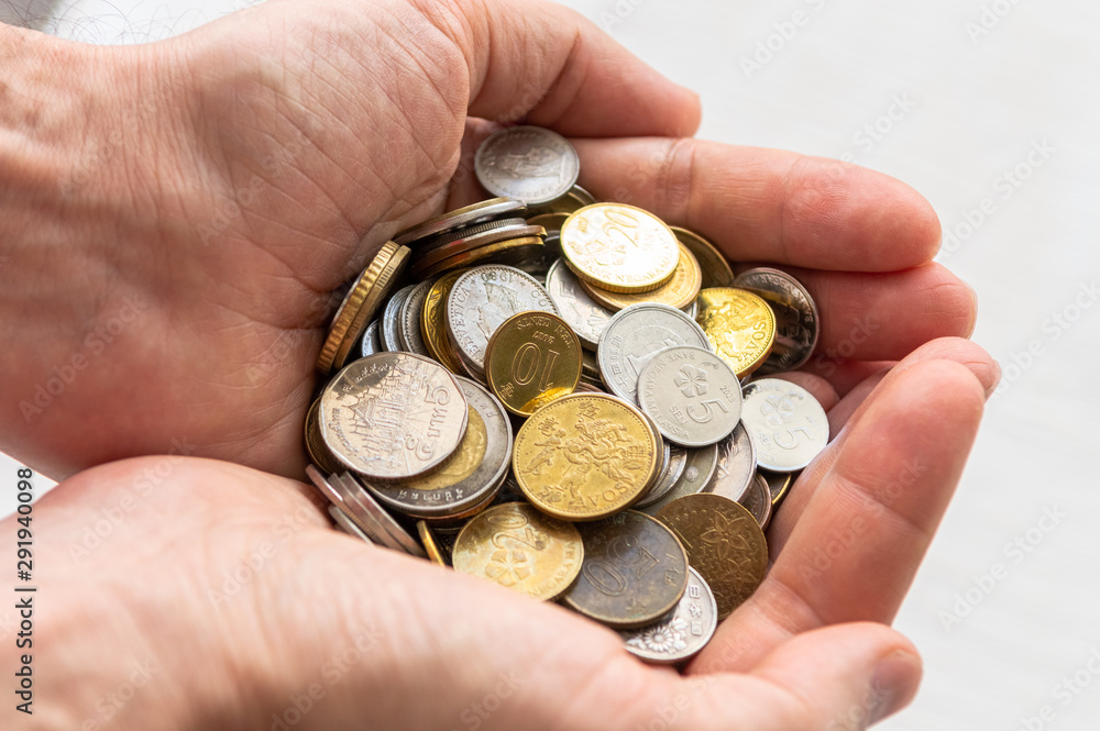 Close up of male hands full of silver and golden coins. Business profit concept. Close up of male hands full of silver and golden coins. Business profit concept.