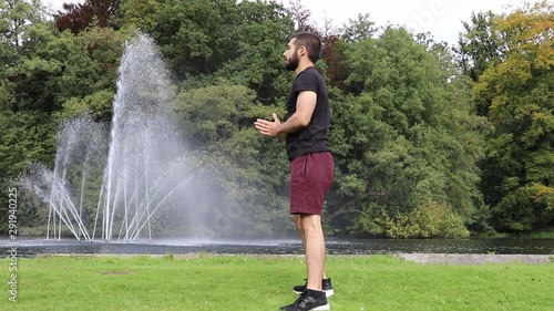 Man doing squats in park side view