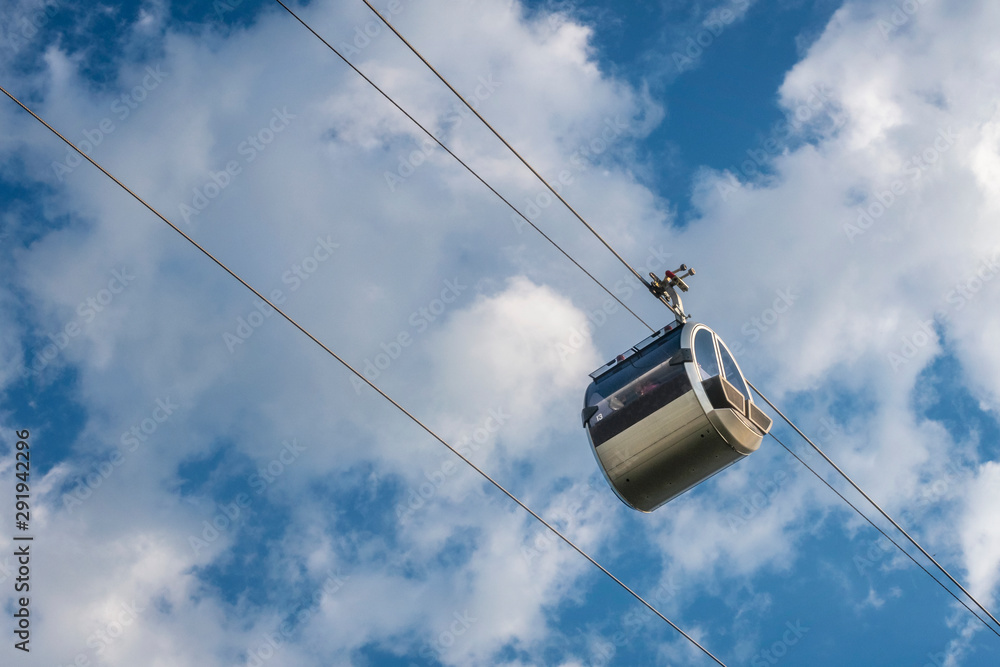 Cable car against blue sky with white clouds. Cable car connects Sparrow Hills (well known as Vorobyevy Gory park) with Sport Complex Luzhniki. Moscow, Russia.