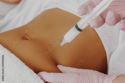 Woman's having lipolysis treatment