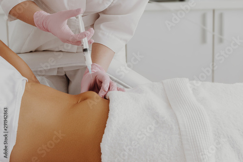 Woman's having lipolysis treatment