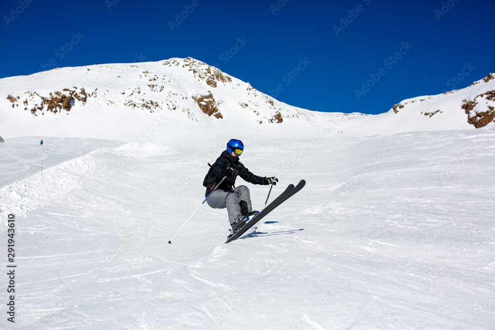 Happy people, children and adults, skiing on a sunny day in Tyrol mountains