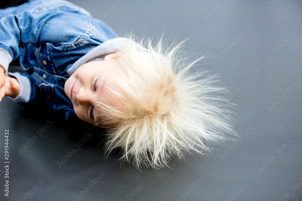 Cute little boy with static electricy hair, having his funny portrait taken outdoors Cute little boy with static electricy hair, having his funny portrait taken outdoors