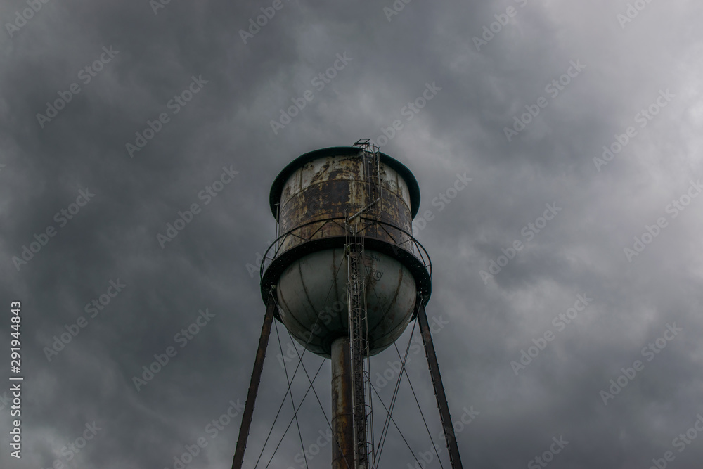 water tower with clouds