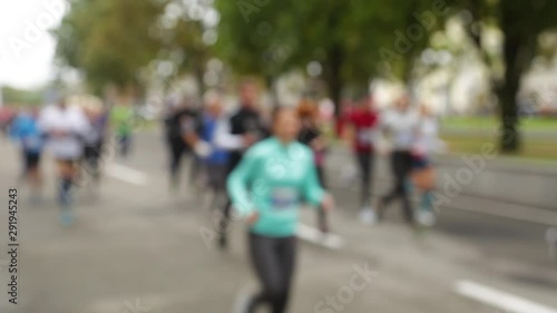 Wallpaper Mural Closeup view of many blurry silhouettes of people of different ages running outdoor in park by city streets during charity marathon. Torontodigital.ca
