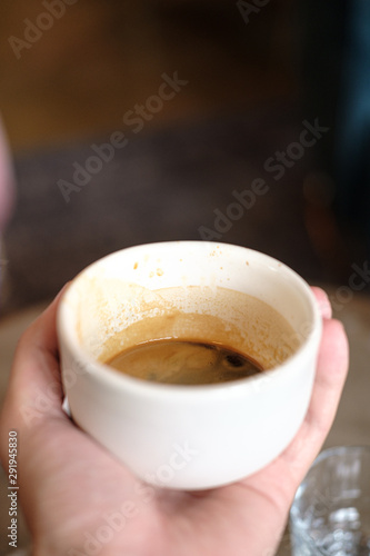 cup with black coffee in hand