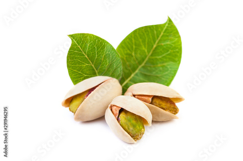 Pistachio nuts with leaves isolated on white background