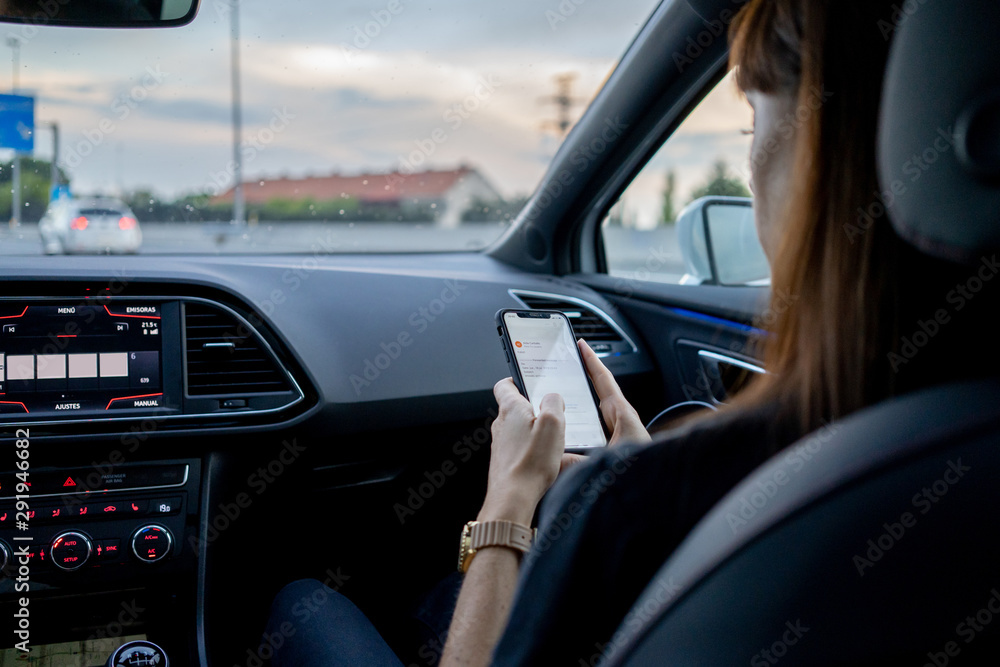 Woman using phone traveling in car Woman using phone traveling in car