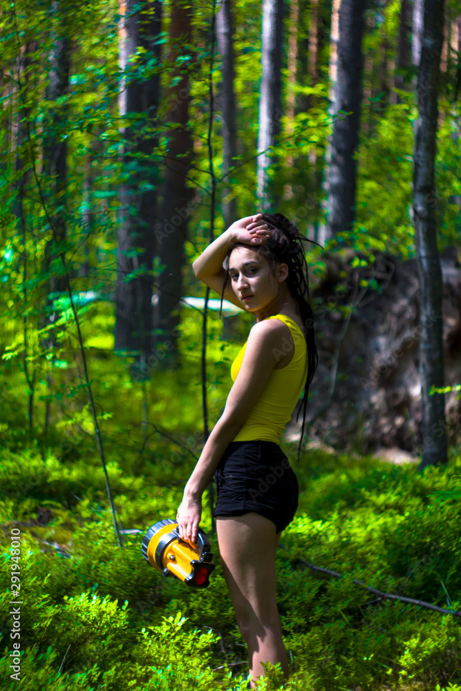 beautiful girl with dreadlocks in summer forest with a lantern beautiful girl with dreadlocks in summer forest with a lantern