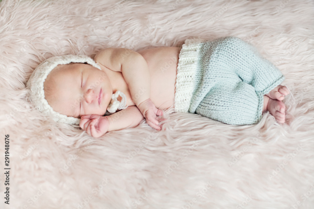 Sleeping Newborn baby on white fluffy blanket