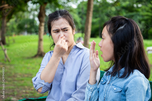 Картината върху платно Asian daughter child girl checking breath teenager girl horrible bad breath,foul