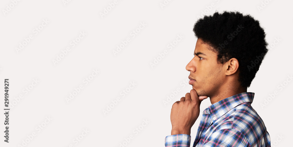 Thoughtful afro guy profile portrait on white background Thoughtful afro guy profile portrait on white background