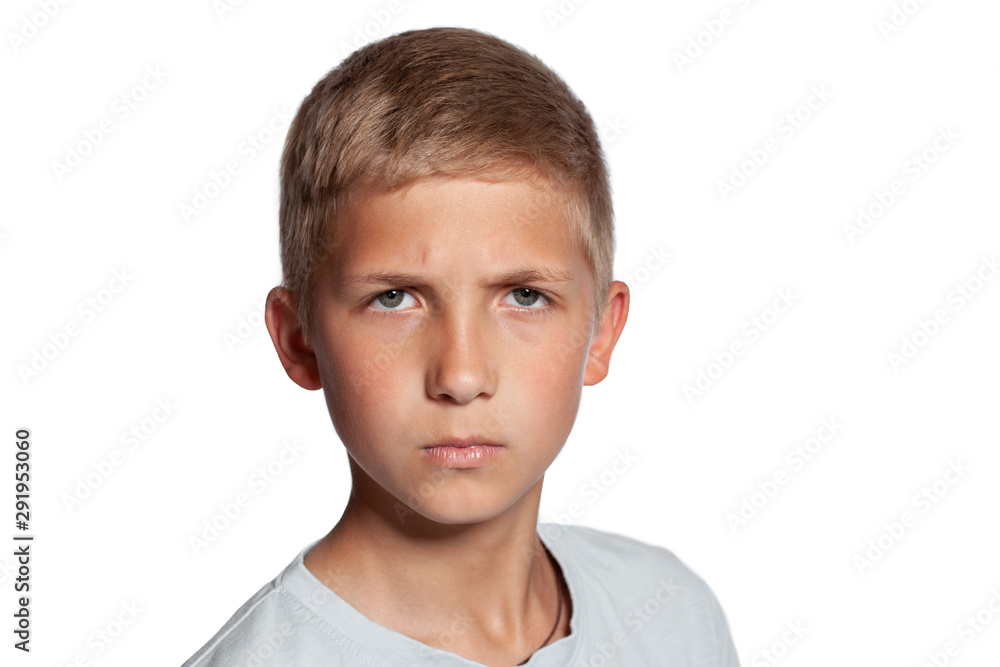Close-up portrait of a blonde teenage boy in a white t-shirt posing isolated on white studio background. Concept of sincere emotions. Close-up portrait of a blonde teenage boy in a white t-shirt posing isolated on white studio background. Concept of sincere emotions.