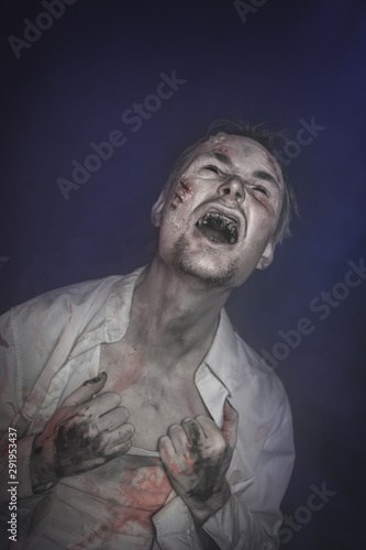 Horror terrible zombie man screaming. Halloween scene