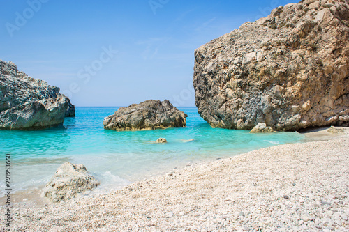 Beautiful sandy beach with turquoise water and big rocks