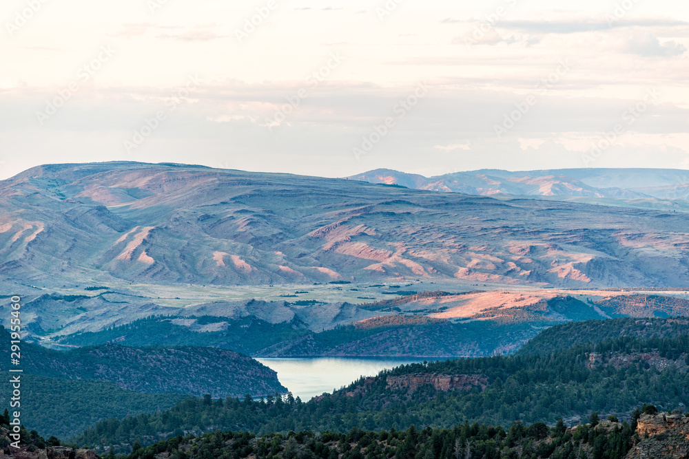 Aerial view of mountains from Canyon Rim trail overlook near campground in Flaming Gorge Utah National Park with Green River at sunset