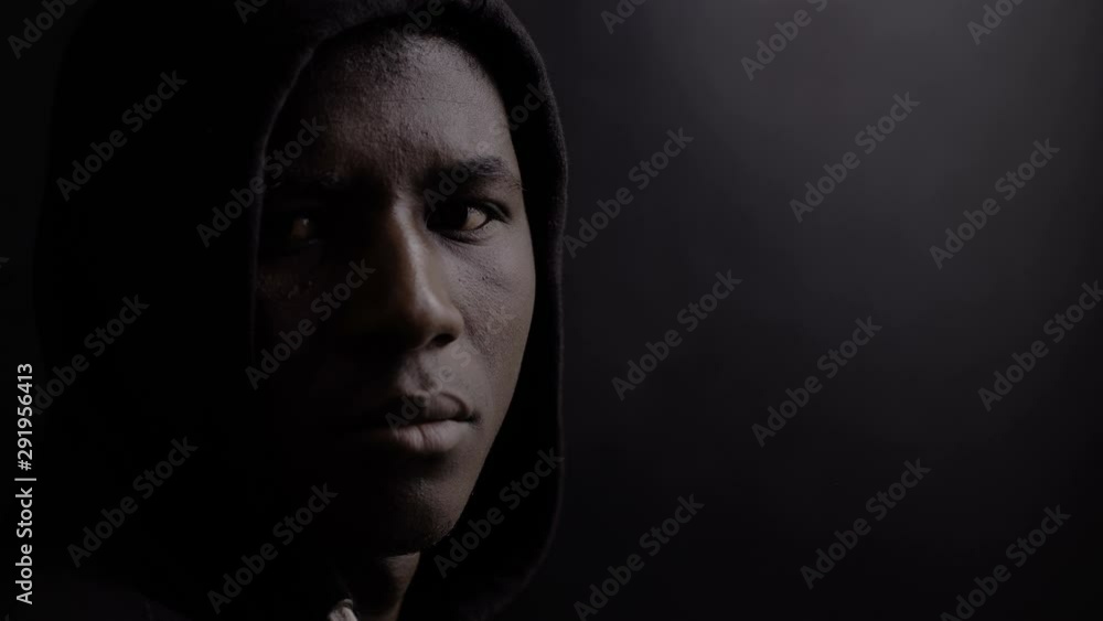immigration, social theme. Serious African immigrant in the dark turns,look immigration, social theme. Serious African immigrant in the dark turns,look
