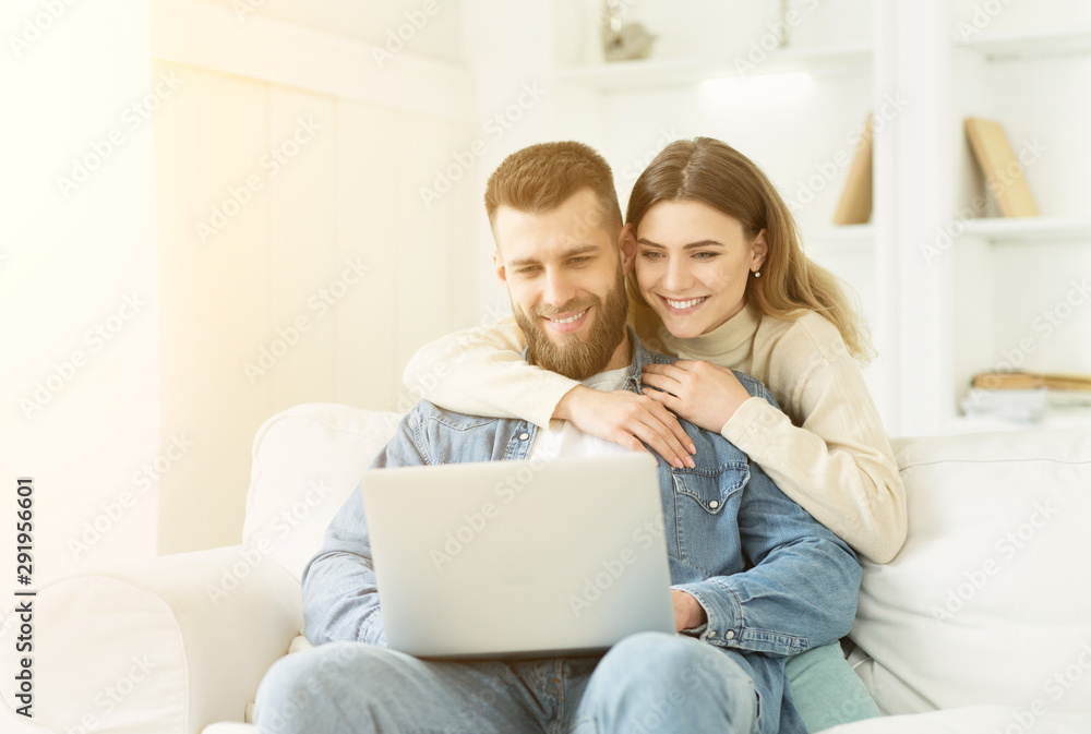 Happy couple having video-call on laptop, spending time at home Happy couple having video-call on laptop, spending time at home