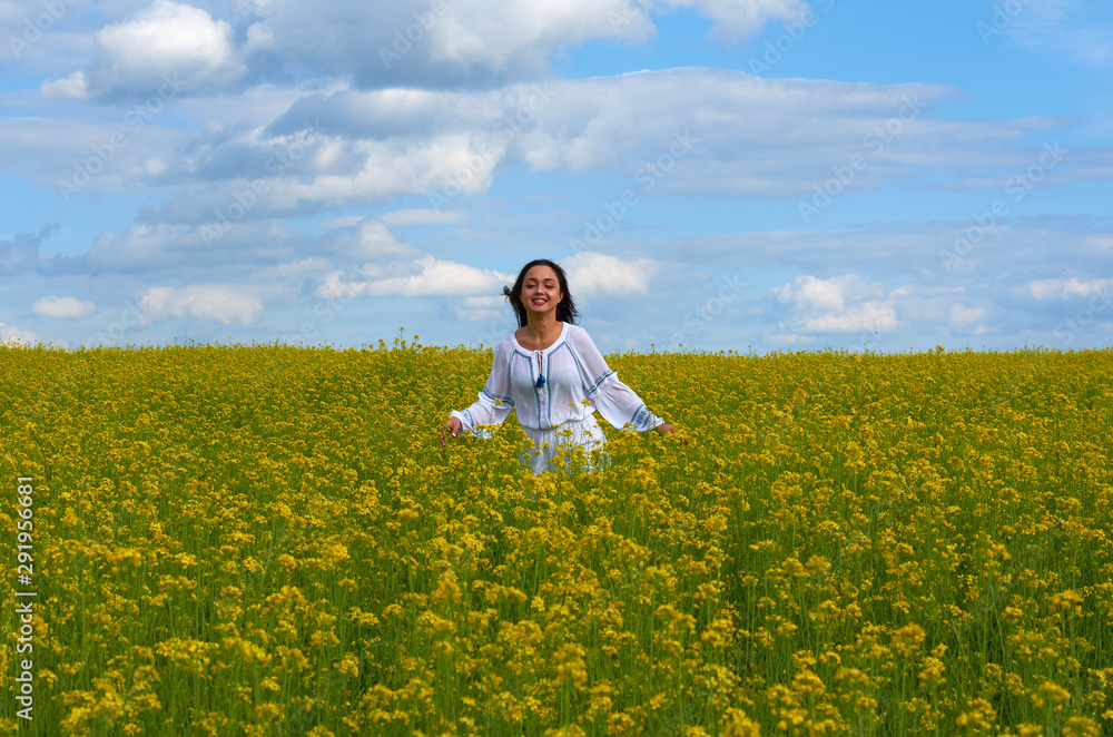 girl in white dress in a field of flowers