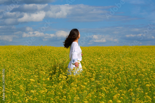 girl in white dress in a field of flowers © евгений ставников