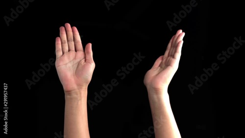 Pair of hands coming upstanding like two personalities and fighting arguing with each other isolated on black background. photo