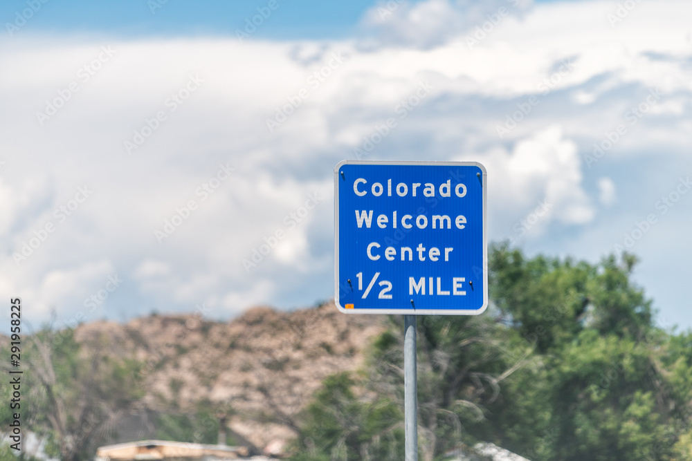Colorado welcome center sign closeup on road in Dinosaur town city during summer
