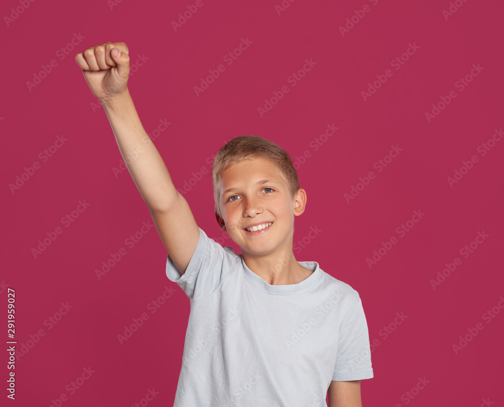 Close-up portrait of a blonde teenage boy in a white t-shirt posing against a pink studio background. Concept of sincere emotions. Close-up portrait of a blonde teenage boy in a white t-shirt posing against a pink studio background. Concept of sincere emotions.