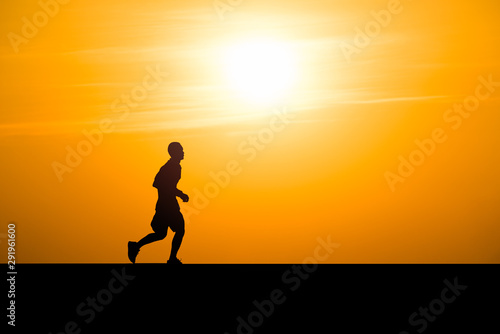 Silhouette man running on sunset background