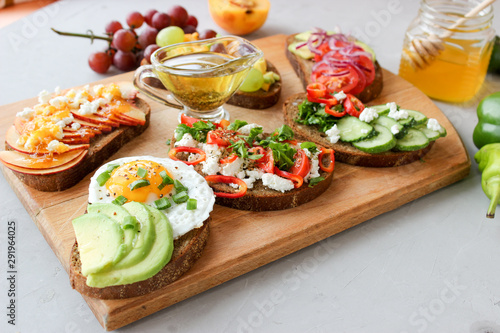 Useful sandwiches stuffed with avocado, scrambled eggs, cottage cheese and fruit