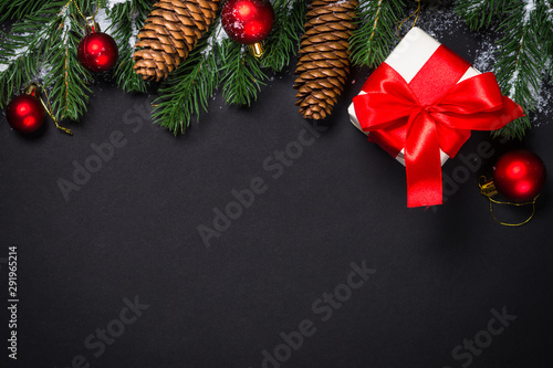 Christmas background with decorations on black.