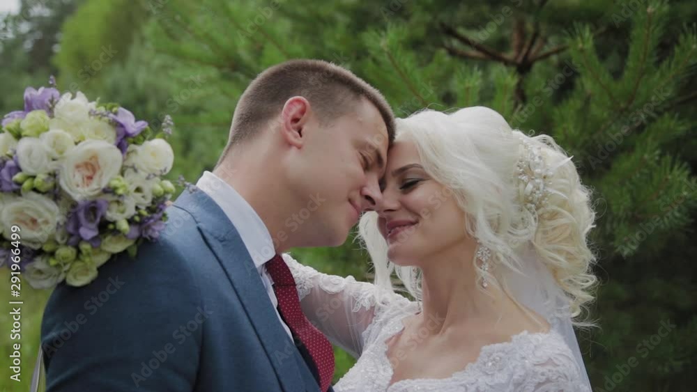 Very beautiful bride and groom hold hands and hug in the forest. Very beautiful bride and groom hold hands and hug in the forest.